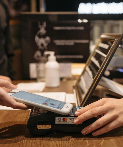 A customer using automated wireless payment at a shop.